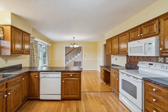 a kitchen with a stove top oven sink and cabinets