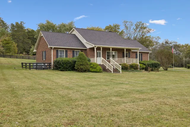 a view of a hallway view with wooden floor and staircase