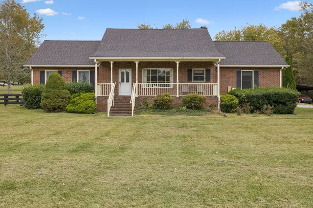 an empty room with a fireplace and a ceiling fan