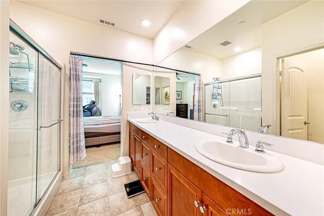 a spacious bathroom with a sink double vanity and a mirror