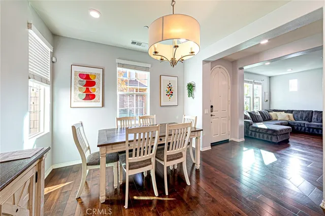a view of a dining room with furniture wooden floor and chandelier