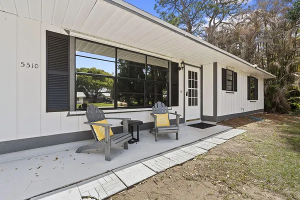 a building outdoor space with patio furniture and potted plants