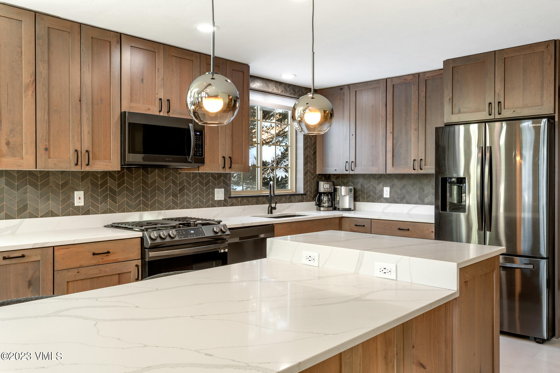 160 Nottingham Road, Unit 1 Avon, CO 81620 - Photo 17 of 28 a kitchen with stainless steel appliances granite countertop a stove a refrigerator a sink dishwasher and a microwave with wooden cabinets