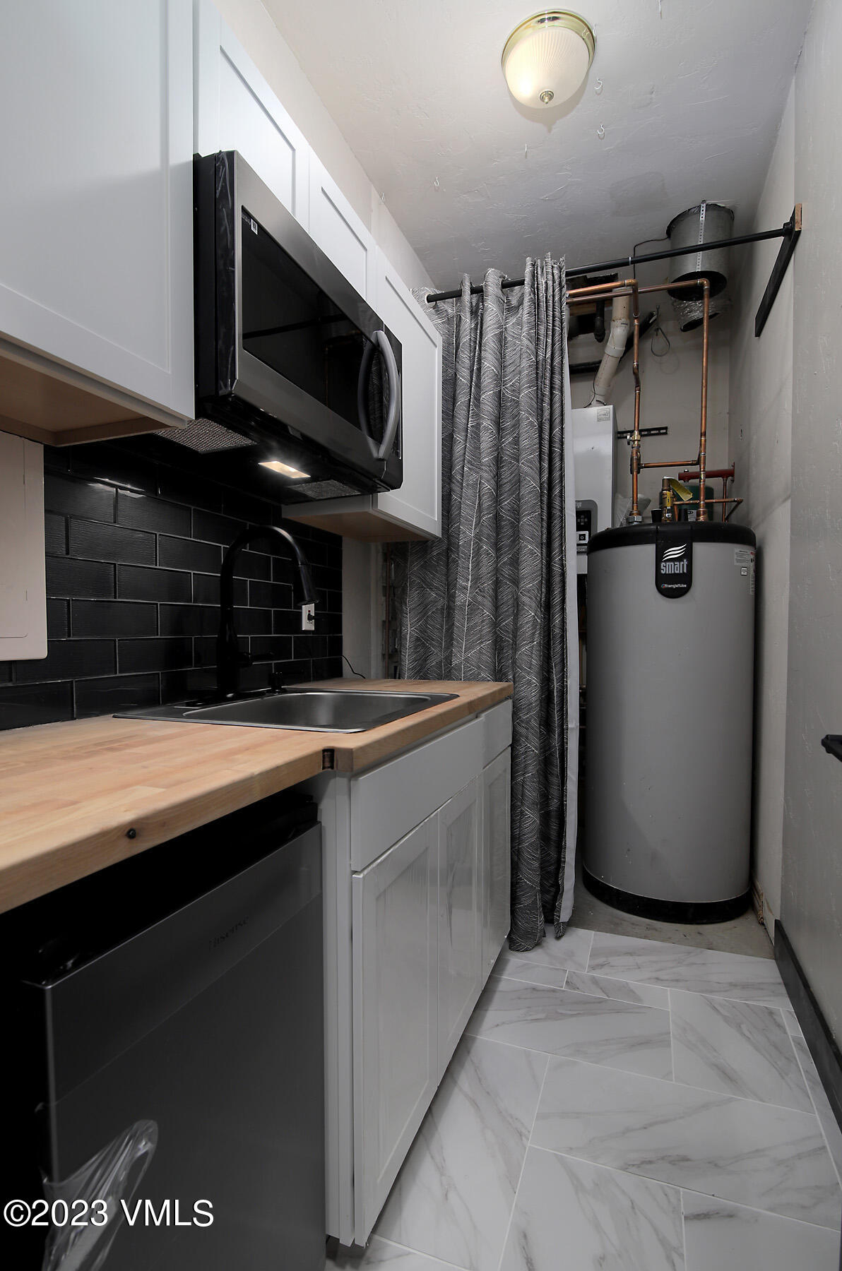 160 Nottingham Road, Unit 1 Avon, CO 81620 - Photo 26 of 28 a kitchen with stainless steel appliances granite countertop a refrigerator a stove and a sink