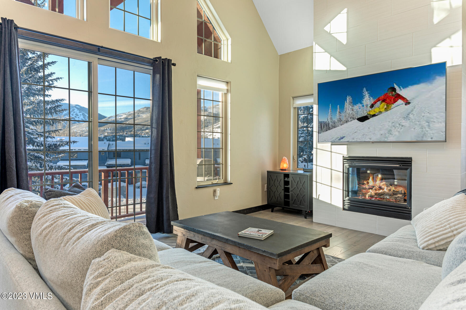 160 Nottingham Road, Unit 1 Avon, CO 81620 - Photo 6 of 28 a living room with furniture a floor to ceiling window and a fireplace