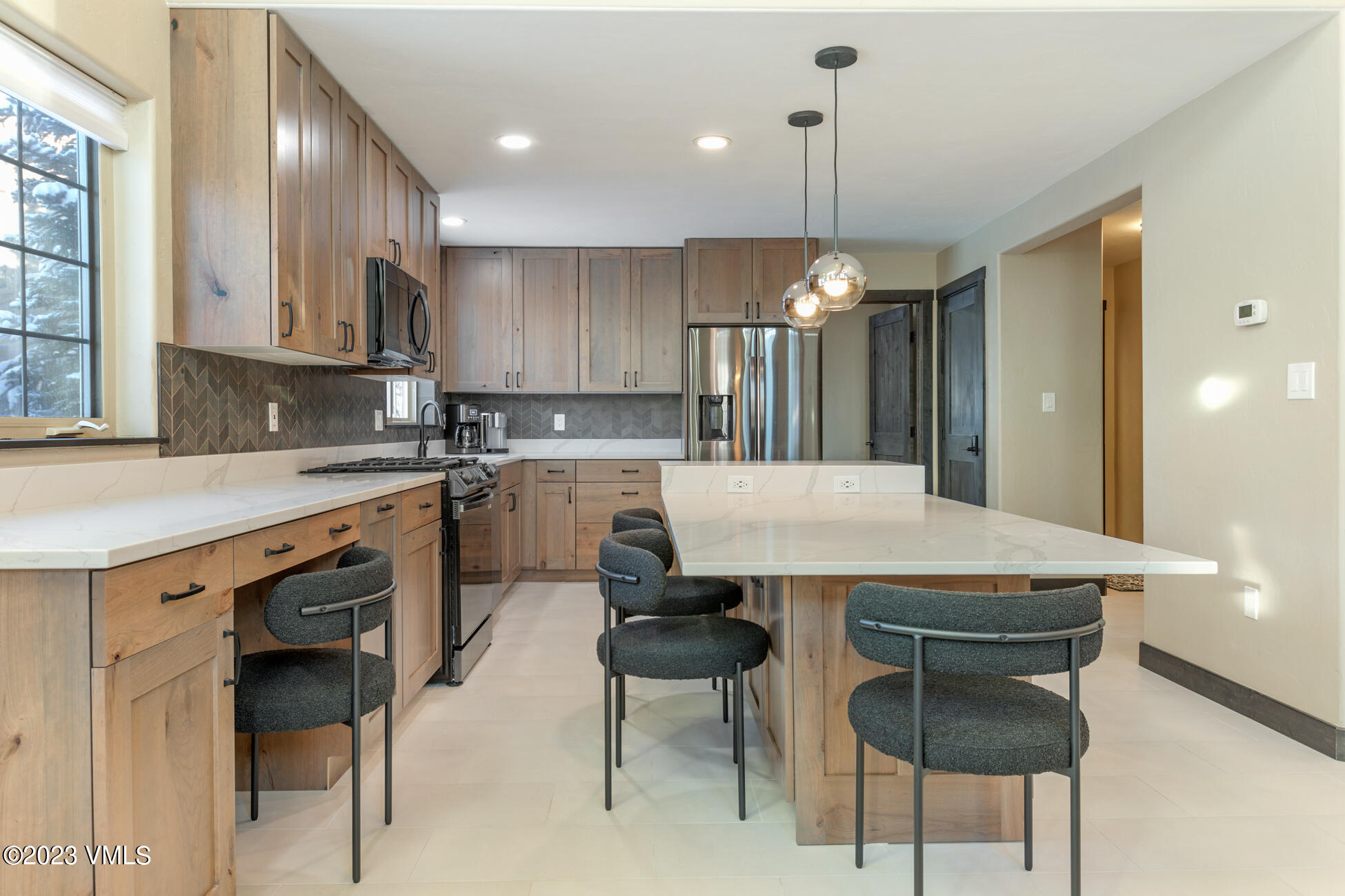 160 Nottingham Road, Unit 1 Avon, CO 81620 - Photo 8 of 28 a kitchen with a dining table chairs refrigerator and cabinets