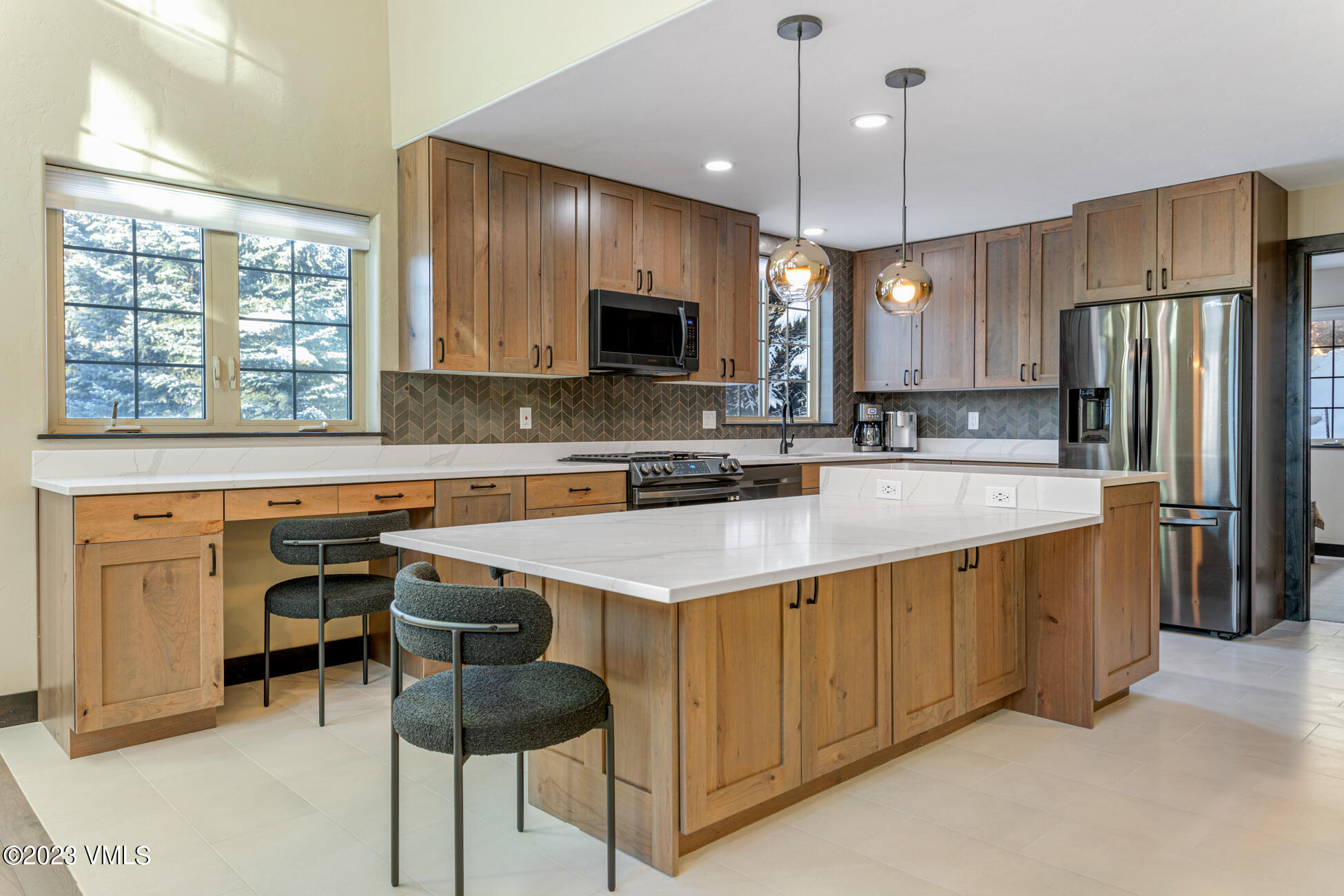 160 Nottingham Road, Unit 1 Avon, CO 81620 - Photo 9 of 28 a kitchen with stainless steel appliances granite countertop a sink a stove a refrigerator cabinets and chairs