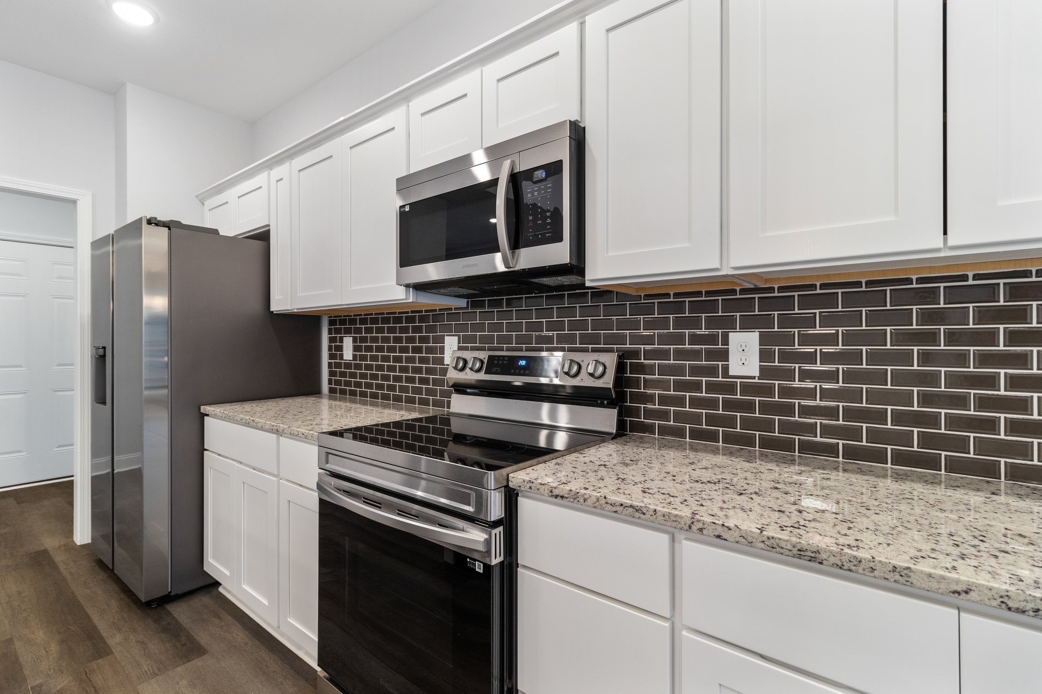 490 Ridge Top Court Clarksville, TN 37040 - Photo 7 of 7 a kitchen with granite countertop a sink stove and microwave