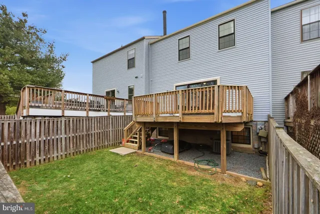 a view of backyard with deck and a garden
