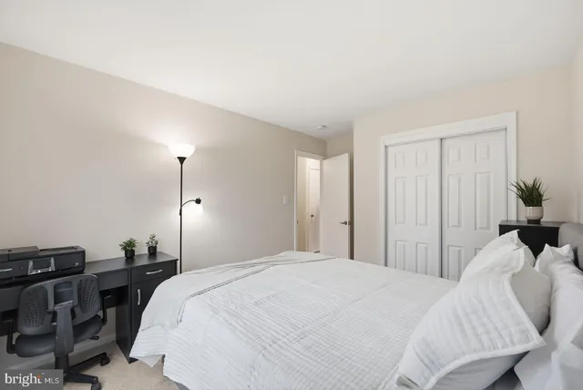 a bedroom with a bed and a potted plant