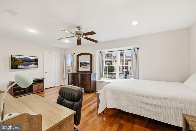 a bedroom with a bed and glass windows