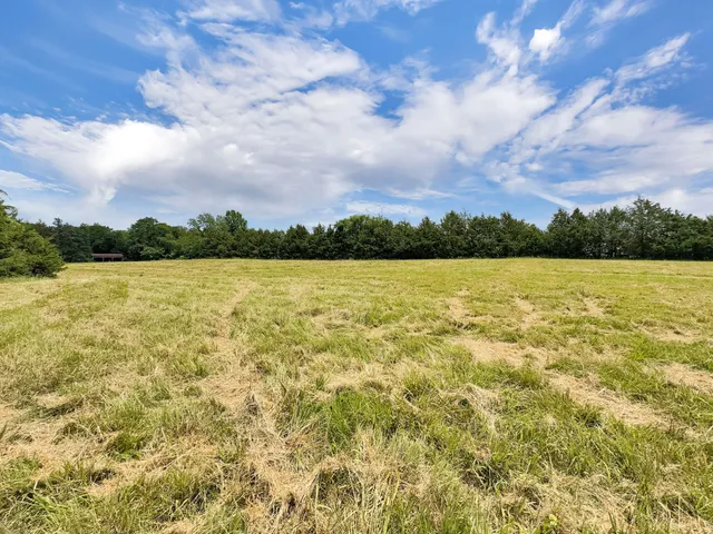 a view of a lake with houses in the back