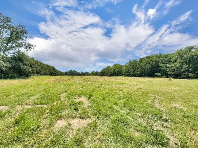 a view of yard with wooden fence