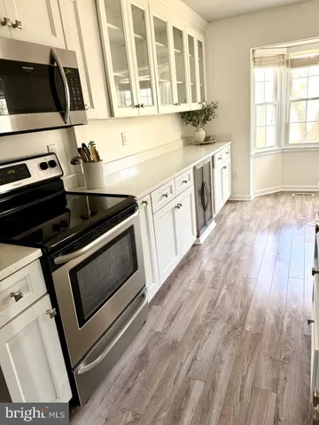 a kitchen with stainless steel appliances a stove a sink and a microwave