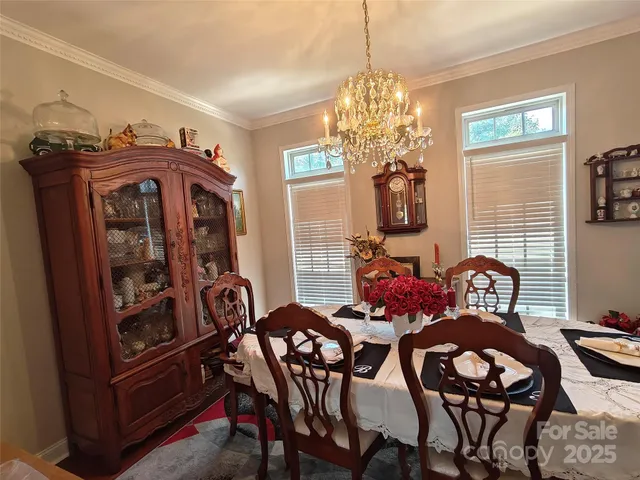 a view of a dining room with furniture and chandelier