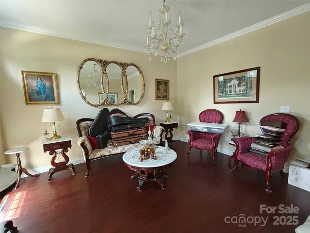 a living room with furniture a rug and a chandelier