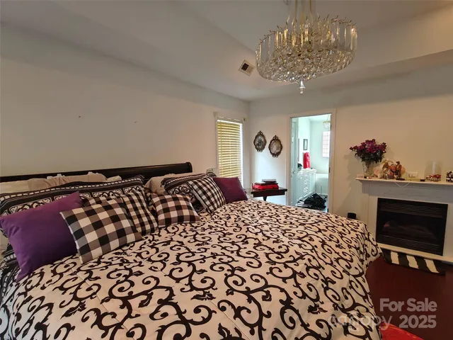 a bedroom with a bed and a chandelier