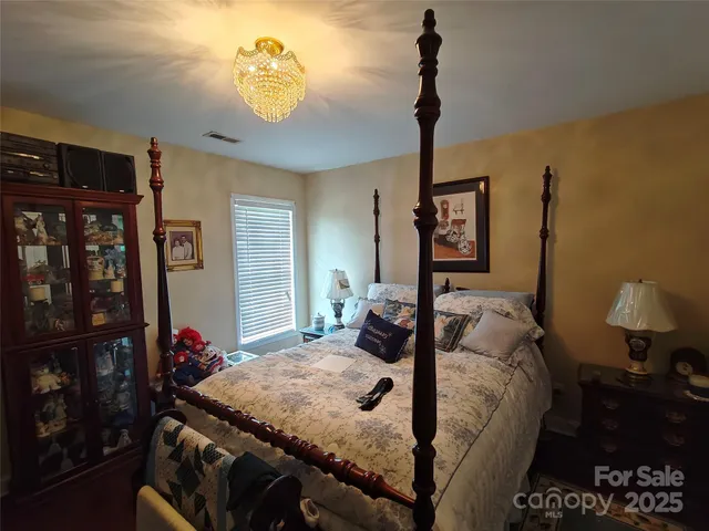 a bedroom with a bed and a lamp on table