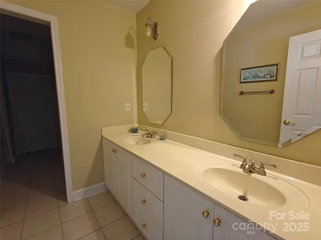 a bathroom with a double vanity sink and mirror