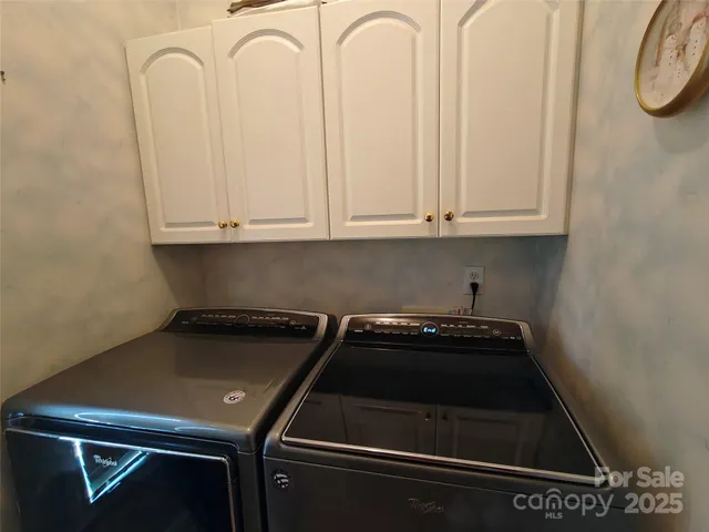 a close view of a utility room with washer and dryer