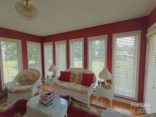 a living room with furniture and floor to ceiling windows