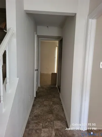 a view of a hallway with wooden floor and closet