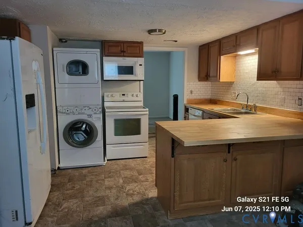 a utility room with sink washer and dryer
