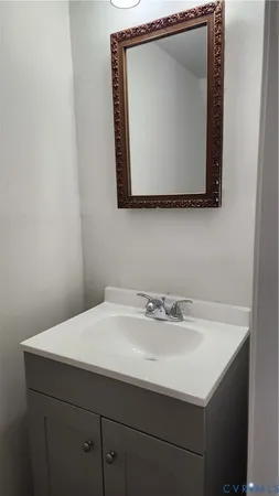 a bathroom with a sink vanity and a mirror