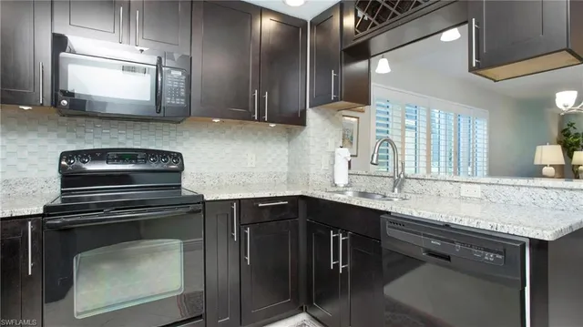 a kitchen with stainless steel appliances a sink stove and cabinets