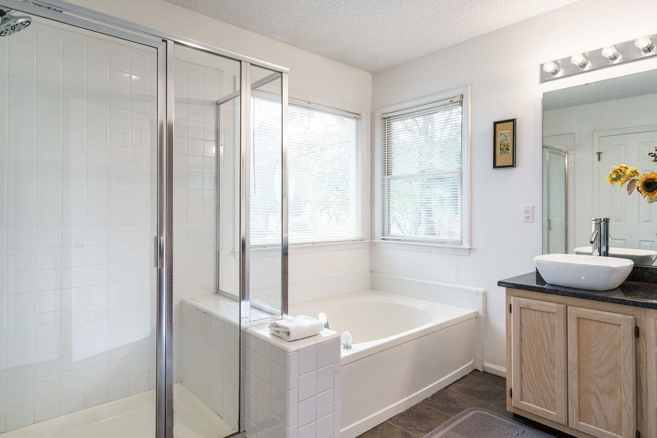 5305 Calverton Drive Raleigh, NC 27613 - Photo 22 of 34 Separate shower, garden tub, and walk-in closet Primary Bathroom