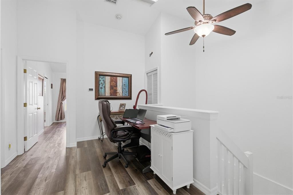 3221 Meta Court Largo, FL 33771 - Photo 16 of 40 a view of a workspace with furniture and wooden floor
