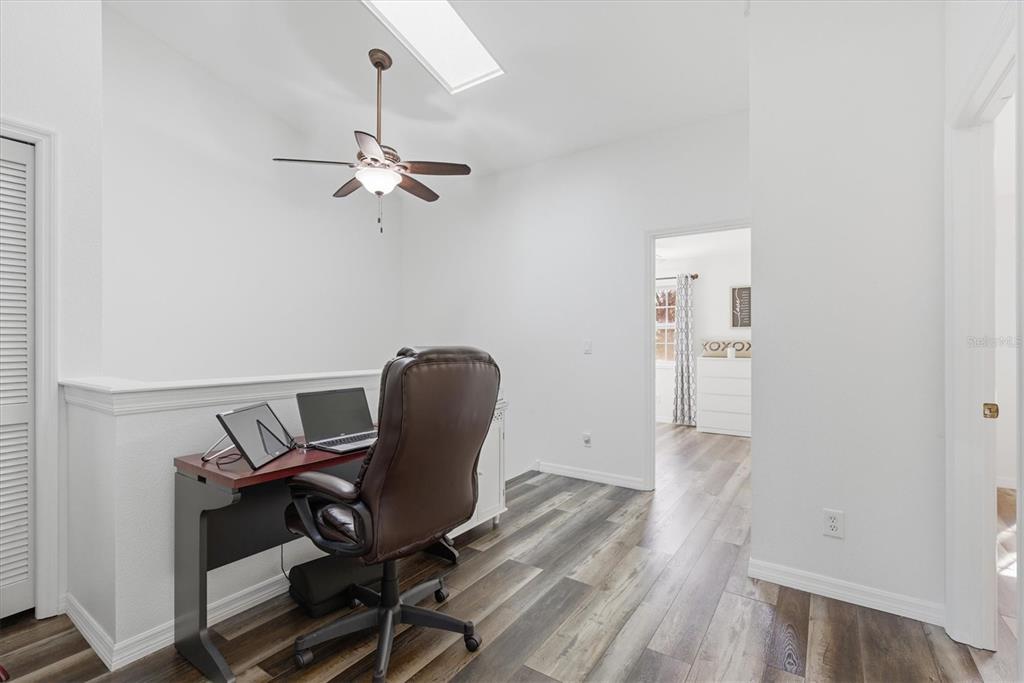3221 Meta Court Largo, FL 33771 - Photo 17 of 40 a view of a workspace with furniture and wooden floor