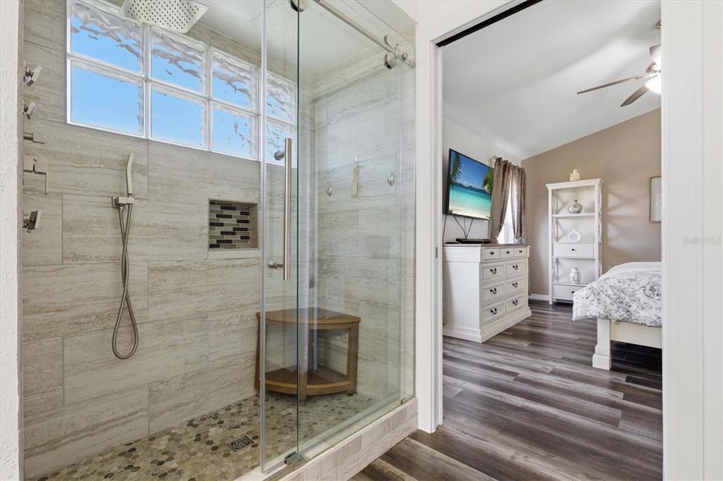 3221 Meta Court Largo, FL 33771 - Photo 21 of 40 a bathroom with a granite countertop shower a mirror and a sink