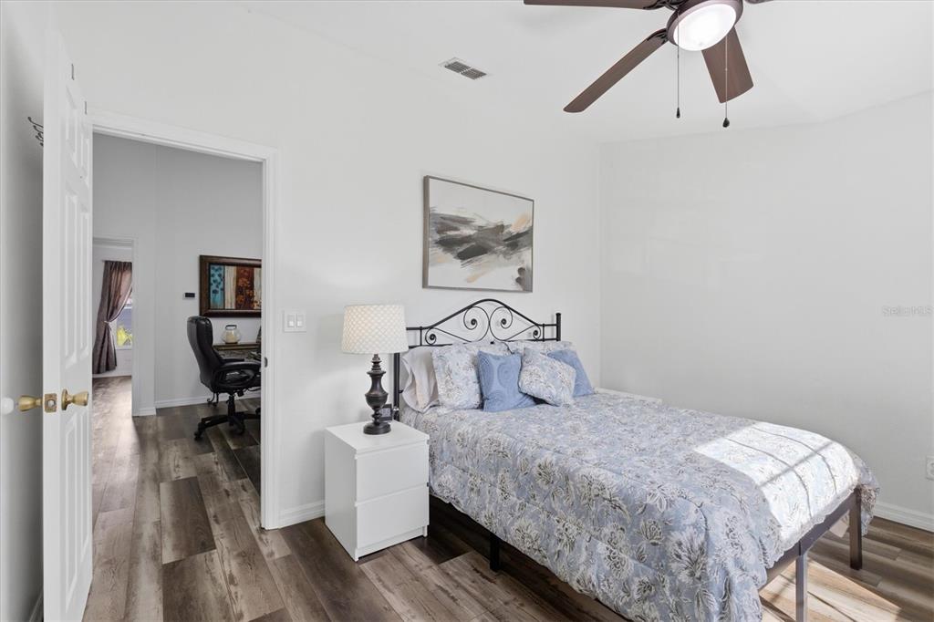 3221 Meta Court Largo, FL 33771 - Photo 25 of 40 a bedroom with a large bed and a chandelier
