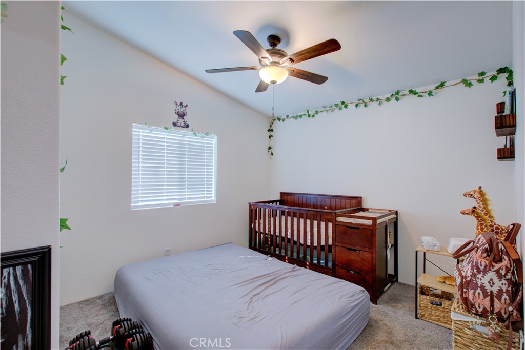 6450 North Winton Way, Unit 76 Winton, CA 95388 - Photo 15 of 38 a bedroom with a bed and a chandelier