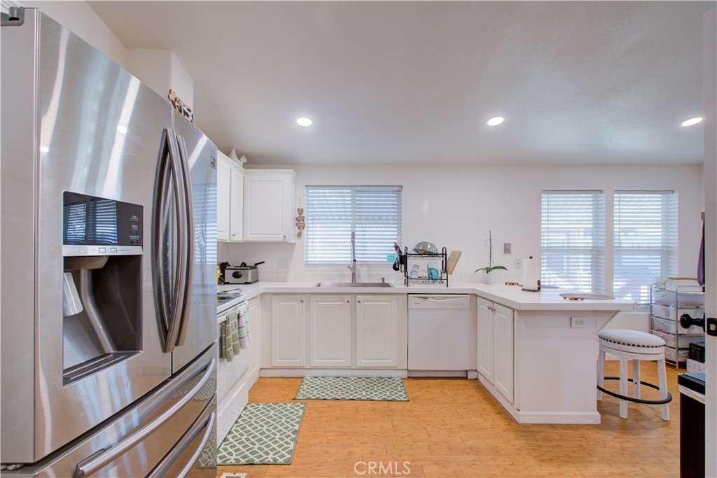 6450 North Winton Way, Unit 76 Winton, CA 95388 - Photo 2 of 38 a kitchen with stainless steel appliances a sink a stove a refrigerator cabinets and a window