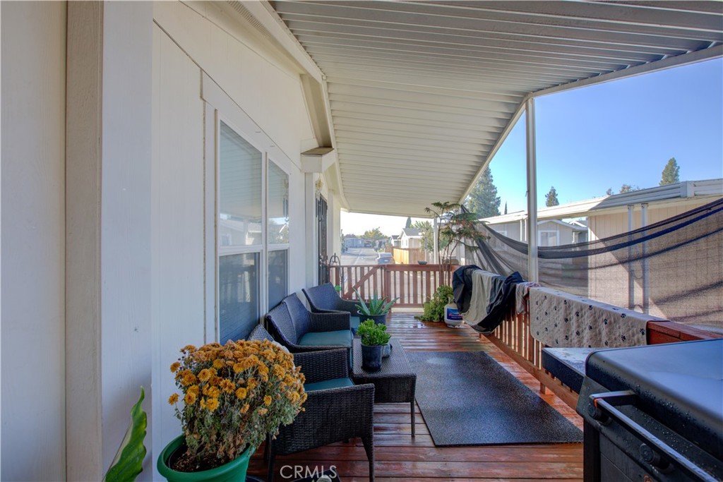 6450 North Winton Way, Unit 76 Winton, CA 95388 - Photo 23 of 38 a balcony with furniture and wooden floor