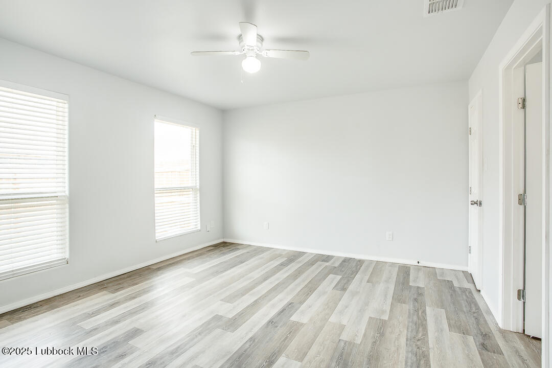 5514 Jarvis Street Lubbock, TX 79416 - Photo 11 of 16 wooden floor in an empty room with a window