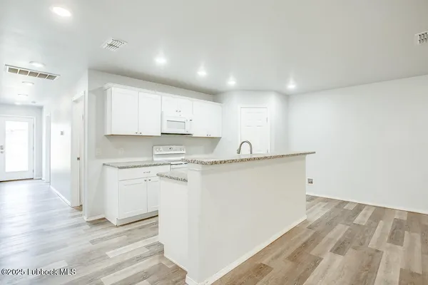 a kitchen with a sink and a refrigerator