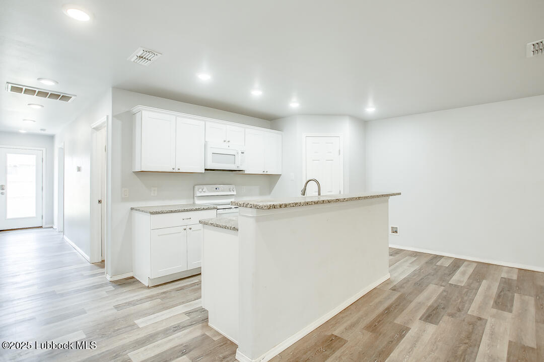 5514 Jarvis Street Lubbock, TX 79416 - Photo 8 of 16 a view of kitchen with wooden floor