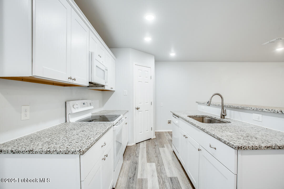 5514 Jarvis Street Lubbock, TX 79416 - Photo 10 of 16 a kitchen with a sink and cabinets