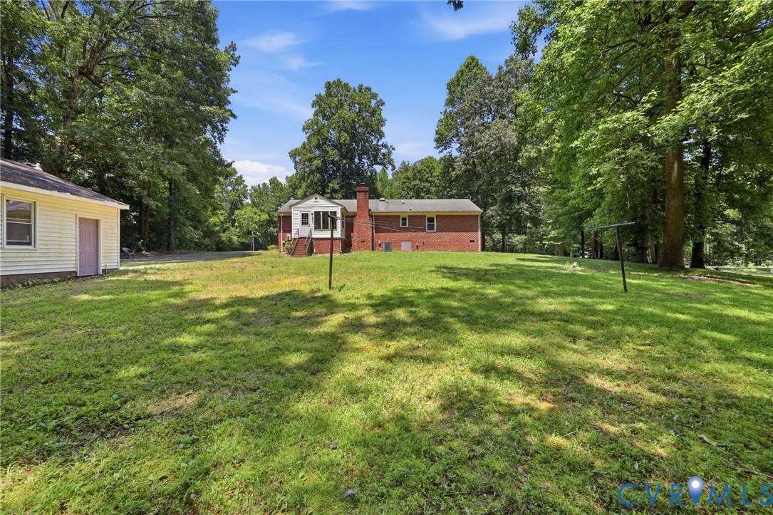 10111 Tunstall Road New Kent, VA 23124 - Photo 41 of 52 Expansive grassy yard area with mature trees and a