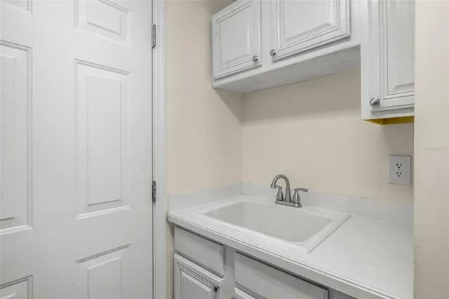 a spacious bathroom with a sink a mirror and shower