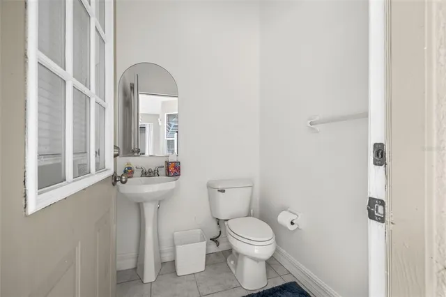 an aerial view of residential houses with outdoor space and trees all around