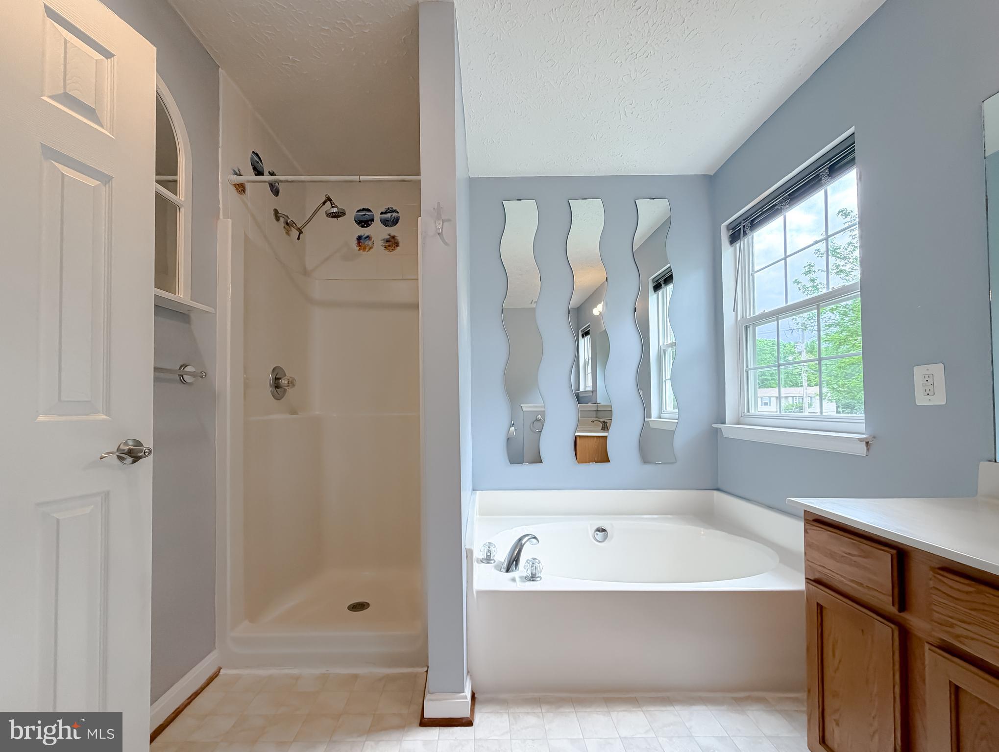 23801 McIntosh Road Hollywood, MD 20636 - Photo 16 of 35 a bathroom with a bathtub a shower and a sink