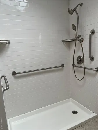 a bathroom with a bath tub with a shower