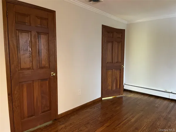 an empty room with wooden floor