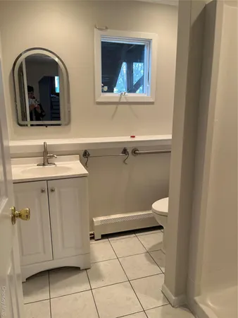 a bathroom with a toilet sink and mirror