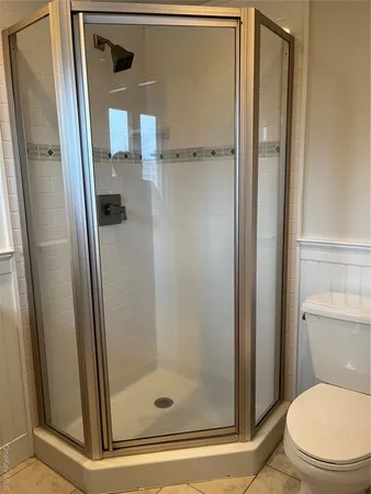 a bathroom with a glass door shower