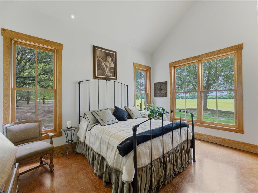 151 Trinity Bluffs Road Aledo, TX 76008 - Photo 25 of 40 a bedroom with a bed and a large window